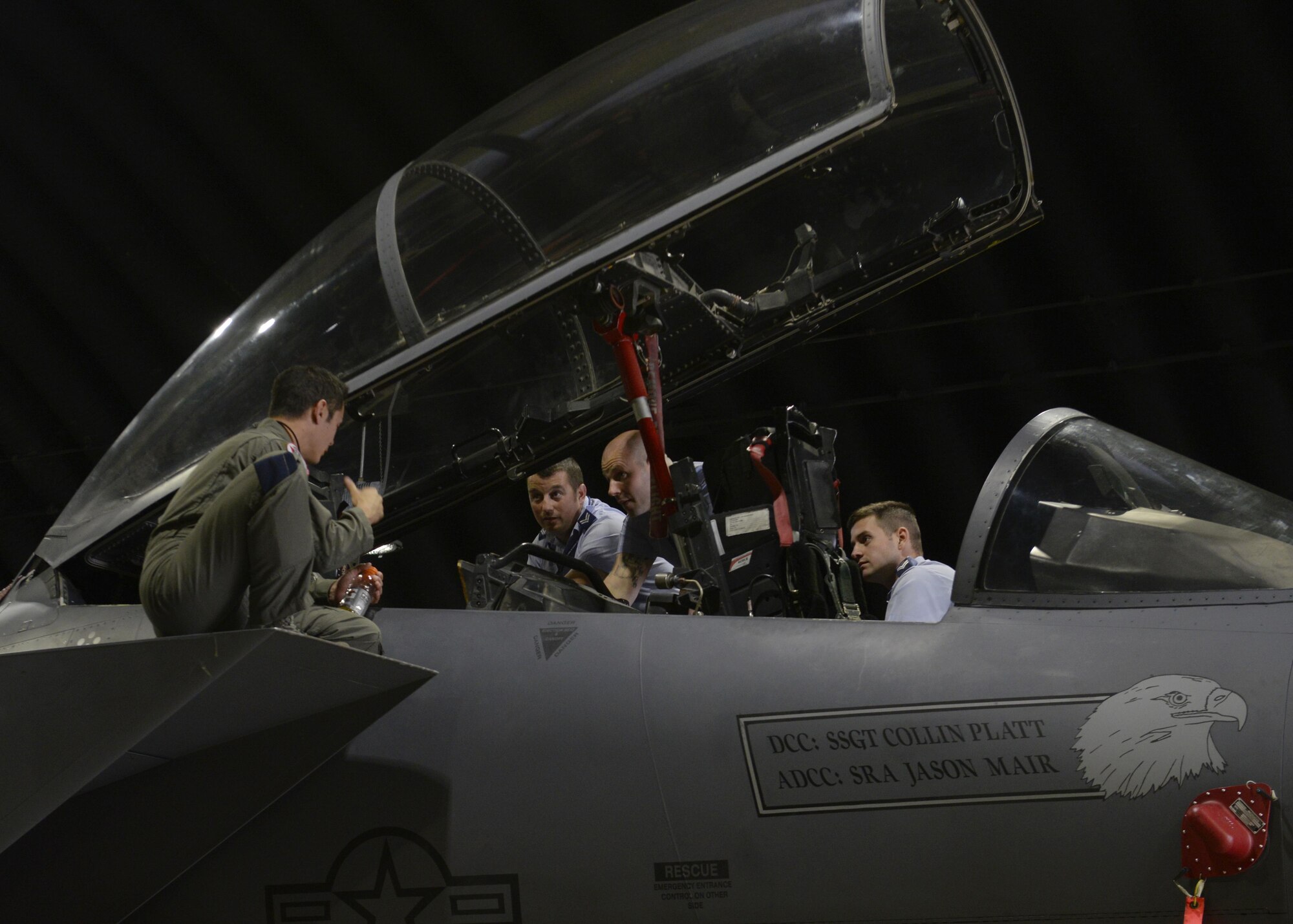 U. S. Air Force Capt. Michael Brewer, left, 494th Fighter Squadron equipment officer and F-15E pilot, shows Royal Air Force Coningsby airmen the inside of an F-15E Strike Eagle cockpit at RAF Lakenheath, England, Aug. 9. Eight RAF airmen were hosted by 48th Operations Support Squadron AFE personnel for a series of tours and demonstrations aimed at introducing them to U.S. Air Force equipment and capabilities. (U.S. Air Force photo by Airman 1st Class Abby L. Finkel) 