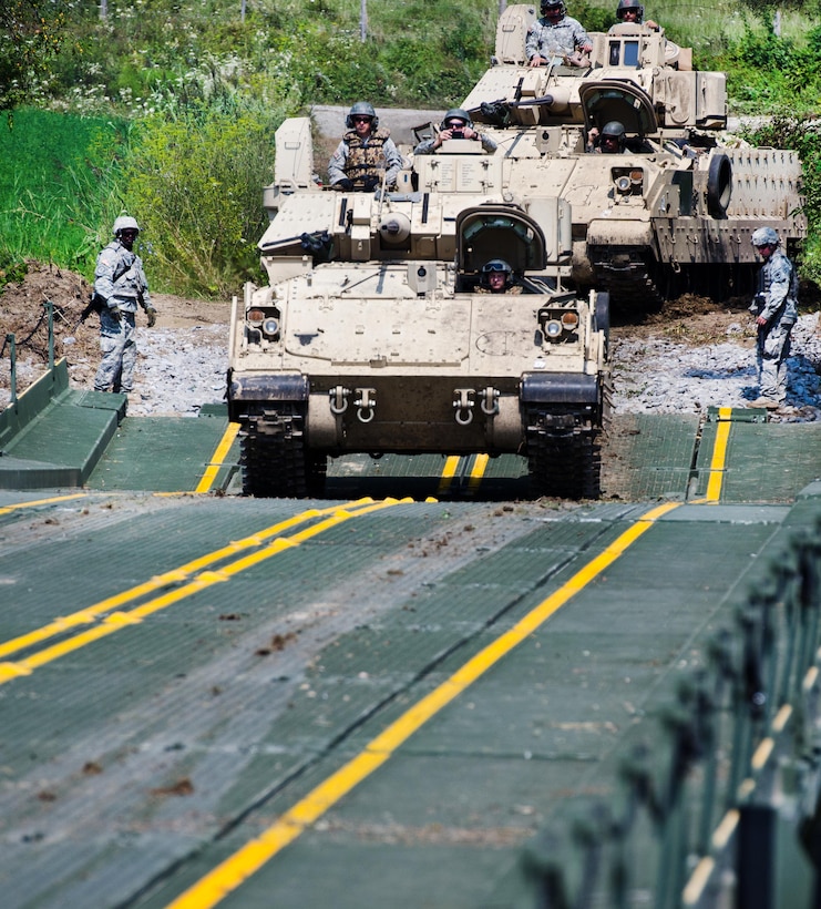 Soldiers drive their M3 Bradley fighting vehicle across an improved ribbon bridge on the Olt River near Voila, Romania, during Exercise Saber Guardian 16,  Aug. 1, 2016.  Army photo by 1st Sgt. Kevin Hartman