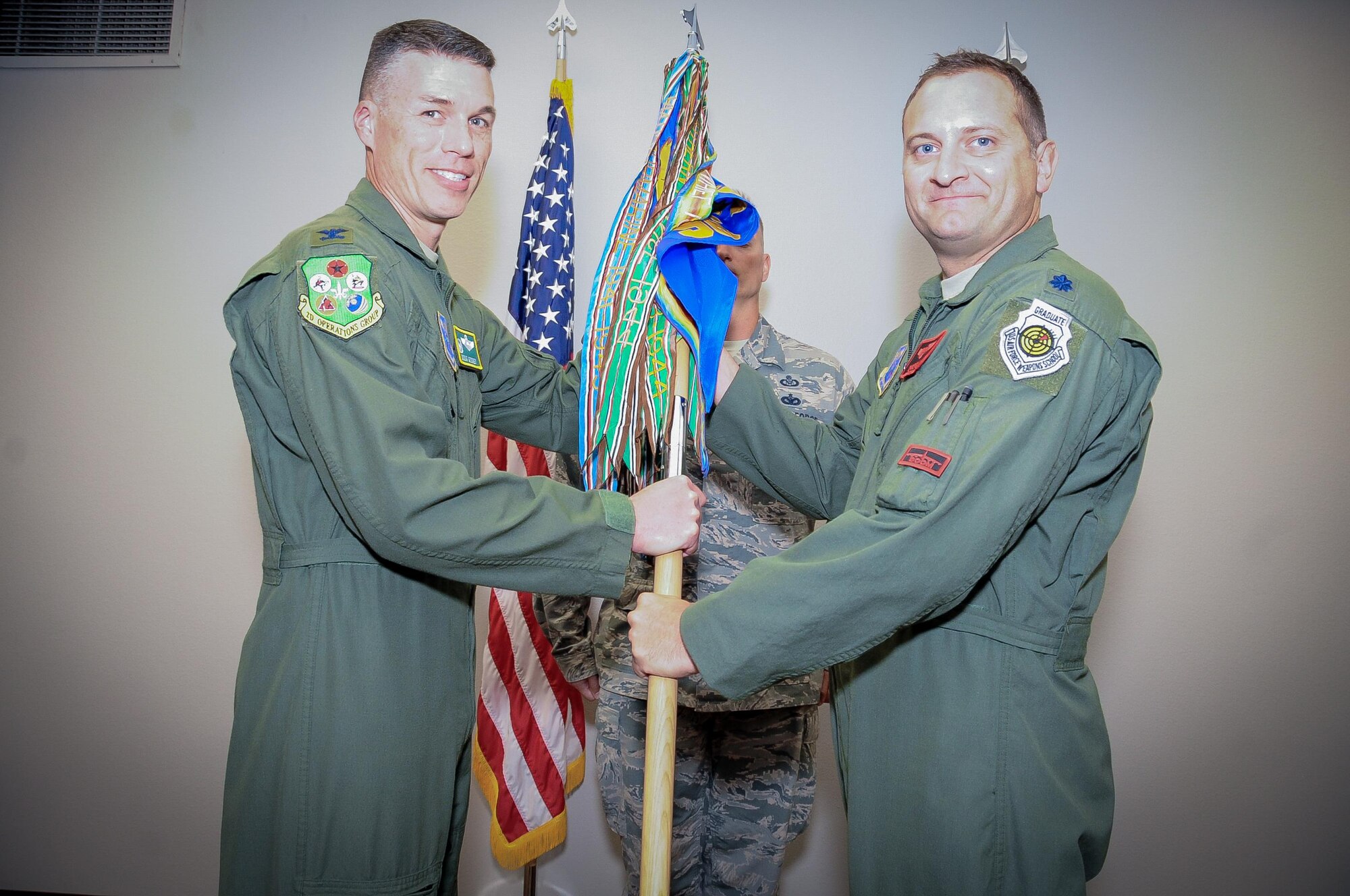 Lt. Col. Christopher Cain accepts command of the 96th Bomb Squadron during a change of command ceremony at Barksdale Air Force Base, La., June 30, 2016. During the permanent change of station season at Barksdale, 19 changes of command took place over the summer months, to include turnover in 13 squadrons and three groups, including the wing itself. (U.S. Air Force photo/ Airman Alexis Frost)