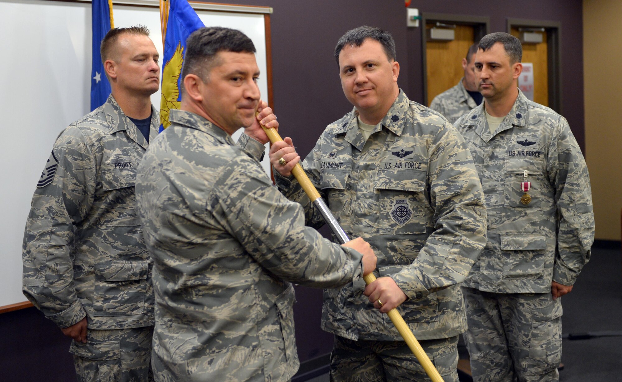 Lt. Col. David Leaumont accepts command of the 2nd Operations Support Squadron during a change of command ceremony at Barksdale Air Force Base, La., July 8, 2016. During the permanent change of station season at Barksdale, 19 changes of command took place over the summer months, to include turnover in 13 squadrons and three groups, including the wing itself. (U.S. Air Force photo/Senior Airman Curt Beach)