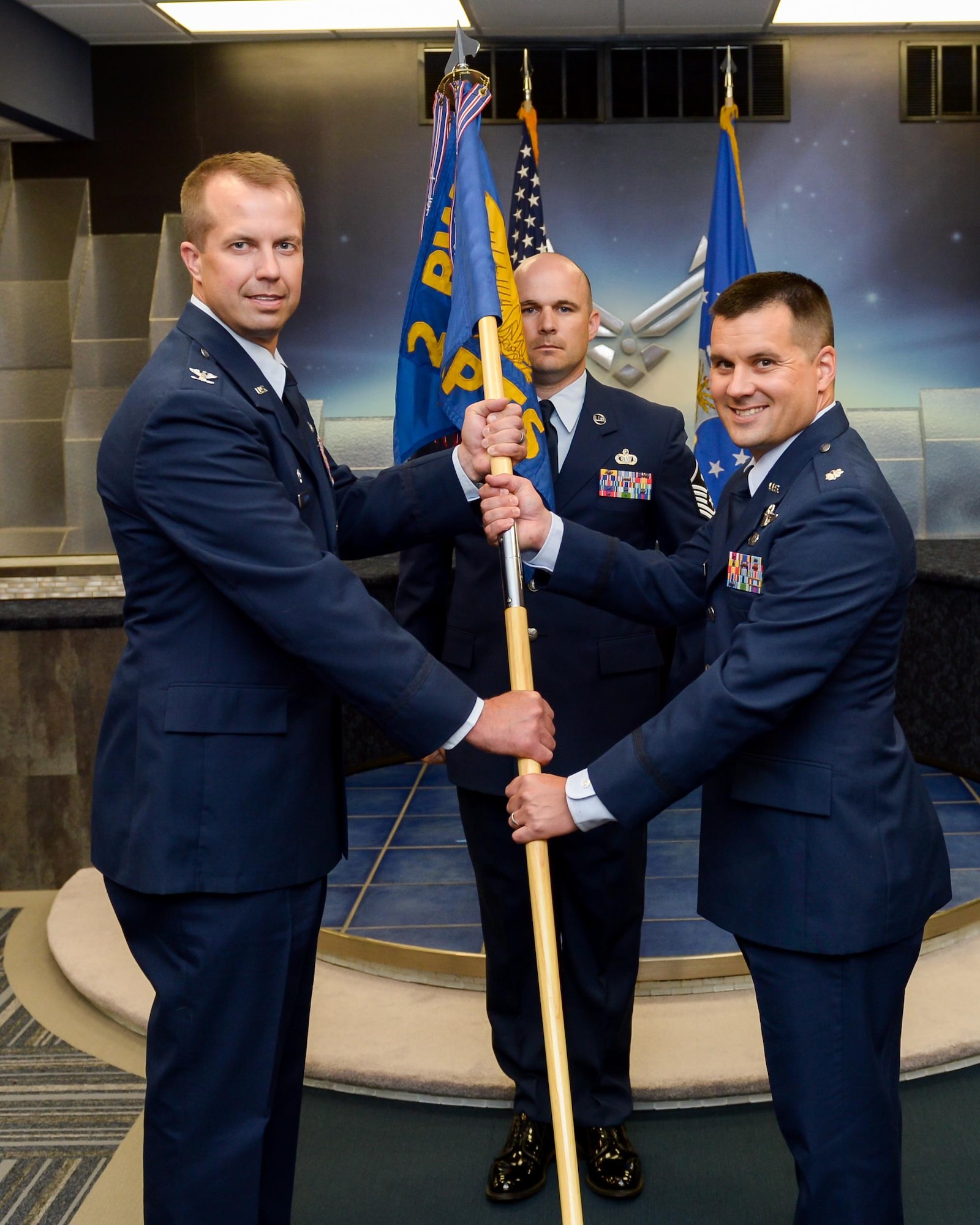Lt. Col. Jason Holcomb accepts command of the 2nd Comptroller Squadron from Col. Ty Neuman, 2nd Bomb Wing commander, at Barksdale Air Force Base, La., July 14, 2016. During the permanent change of station season at Barksdale, 19 changes of command took place over the summer months, to include turnover in 13 squadrons and three groups, including the wing itself. (U.S. Air Force photo/ Senior Airman Mozer O. Da Cunha)