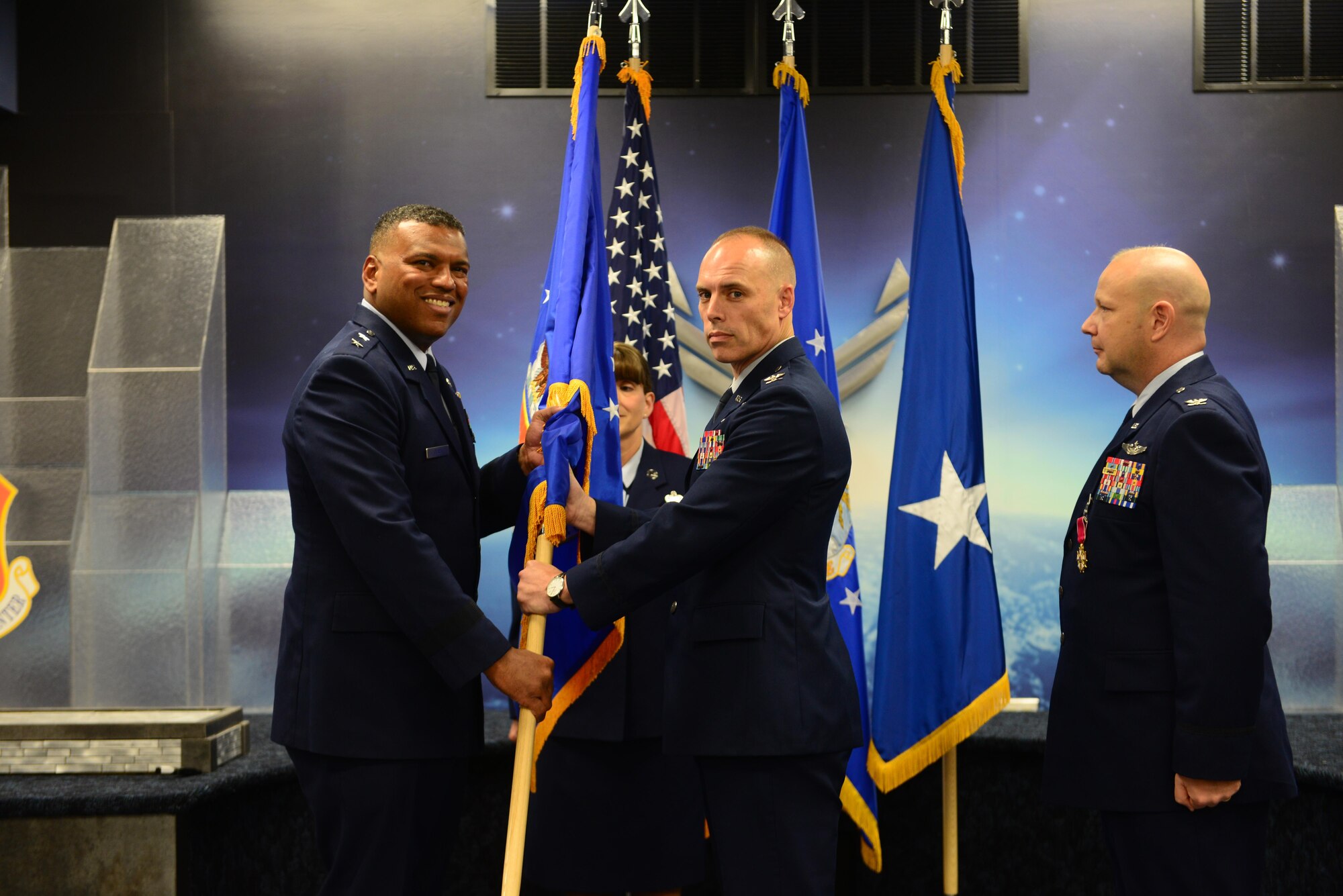 Col. Glen Shilland accepts command of the 608th Air Operations Center from Maj. Gen. Richard Clark, 8th Air Force commander, during a change of command ceremony at Barksdale Air Force Base, La., June 16, 2016. During the permanent change of station season at Barksdale, 19 changes of command took place over the summer months, to include turnover in 13 squadrons and three groups, including the wing itself. (U.S. Air Force photo/ Senior Airman Luke Hill) 