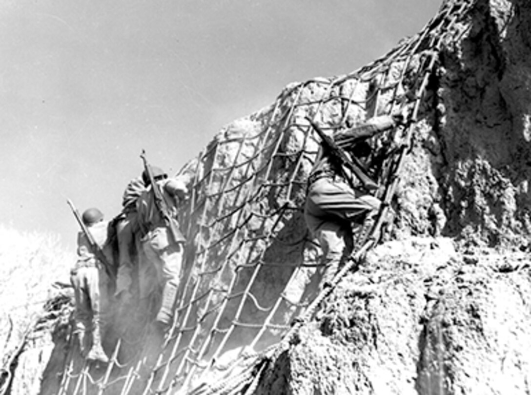 Troops from Fort Huachuca scale cargo nets and assault the ghost town of Charleston, Arizona, to practice house-to-house fighting. Source: Fort Huachuca Military Museum.
