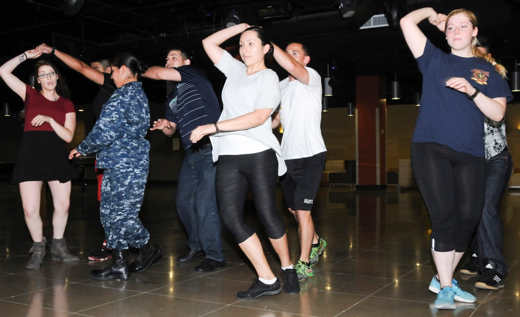 Instructors and students at the Medical Education and Training Campus at Joint Base San Antonio-Fort Sam Houston dance during a class hosted by the Navy Medicine Training Support Center’s Diversity Council at the Student Activity Center. The council began holding the weekly Latin dance class Aug. 3 to help promote cultural awareness and provide a fun recreational activity for students.