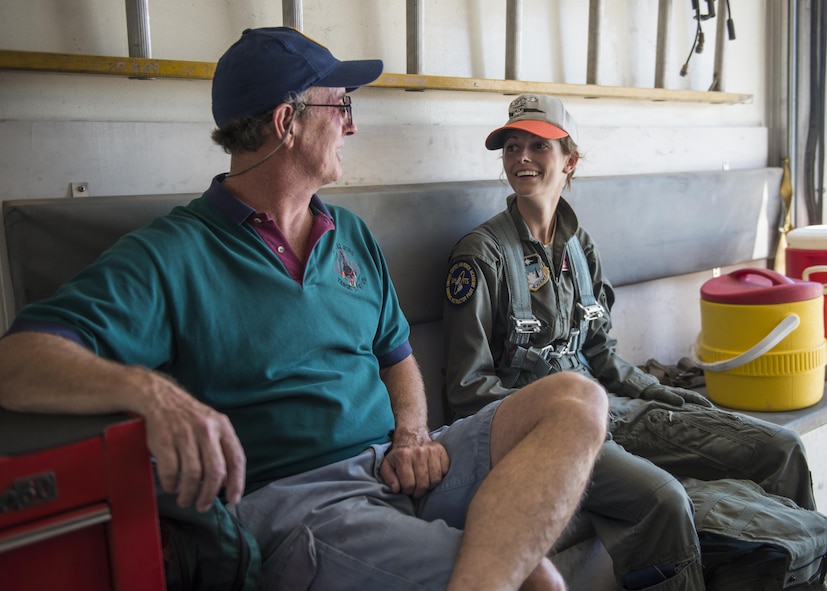 Retired Col. David and his daughter, Cadet 2nd Class Kaitlyn, ride back to the debriefing room after Kaitlyn’s first flight in an Air Force jet July 12, 2016 at Holloman Air Force Base, N.M. David coordinated with Detachment 1 of the 96th Test Group to surprise his daughter with a bucket of water after she got out of the jet. Drenching pilots with water after milestones in their career is a tradition that began in Vietnam, and one that David had the opportunity to pass on to his daughter. (Last names are being withheld due to operational requirements. U.S. Air Force photo by Airman 1st Class Randahl J. Jenson)