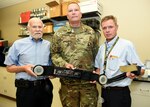 (From left) Michael Dubick, Ph.D., Col. (Dr.) Lance Cordoni and Dr. John Kragh hold a SAM Junctional Tourniquet that was selected as the 2015 Maj. Gen. Harold “Harry” J. Greene Award for Innovation (Group Category) by the U.S. Army Materiel Command.