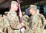 Col. (Dr.) Shawn Nessen (left) takes the U.S. Army Institute of Surgical Research flag from Maj. Gen. Brian Lein, commanding general of U.S. Army Medical Research and Materiel Command and Fort Detrick, Md., July 19. 