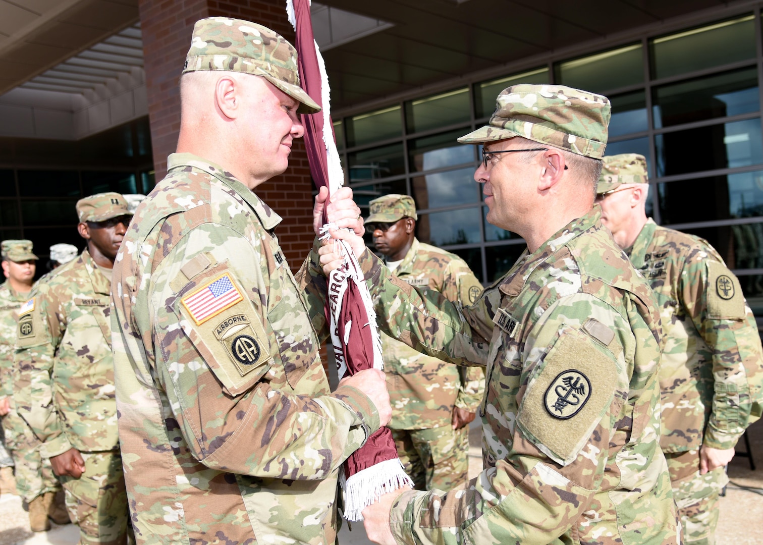 Col. (Dr.) Shawn Nessen (left) takes the U.S. Army Institute of Surgical Research flag from Maj. Gen. Brian Lein, commanding general of U.S. Army Medical Research and Materiel Command and Fort Detrick, Md., July 19. 