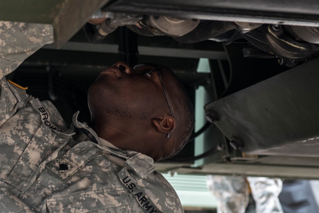 U.S. Army Spc. Anthony Brown, 10th Battalion 149th Seaport Operations Company cargo specialist, checks for leaks under a Kalmar at Fort Eustis, Va., Aug. 8, 2016. Brown operates and maintains all types and sizes of winches, cranes and forklifts. (U.S. Air Force photo by Airman 1st Class Derek Seifert)