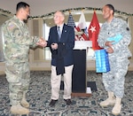 Guest speaker retired Army Maj. Gen. Floyd W. Baker (center) accepts a token of appreciation from Maj. Gen. K.K. Chinn (left), U.S. Army South commanding general, and Chaplain (Lt. Col.) Roy Walker (right), at the conclusion of the command’s quarterly prayer luncheon.