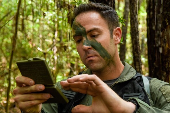 First Lt. James Hendershaw, 336th Fighter Squadron weapon systems officer, applies camouflage paint to his face prior to participating in the Razor Talon exercise, Aug. 5, 2016, near Smyrna, North Carolina. During this Razor Talon scenario, two aircrew members utilized their survival, evasion, resistance and escape training following a simulated aircraft crash. (U.S. Air Force photo by Airman Shawna L. Keyes) 