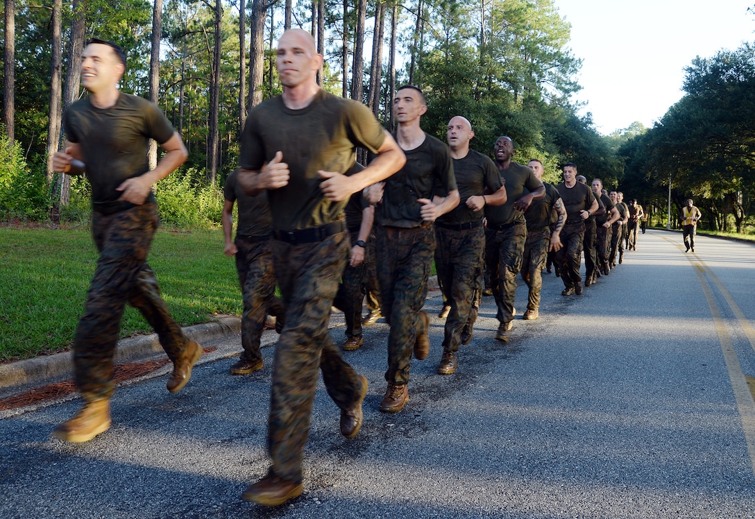 With red Georgia clay caked on their boots and camouflage utility uniform, Marines with Headquarters Company East, Marine Corps Logistics Command, enter the final portion of the motivation run aboard Marine Corps Logistics Base Albany, July 28.