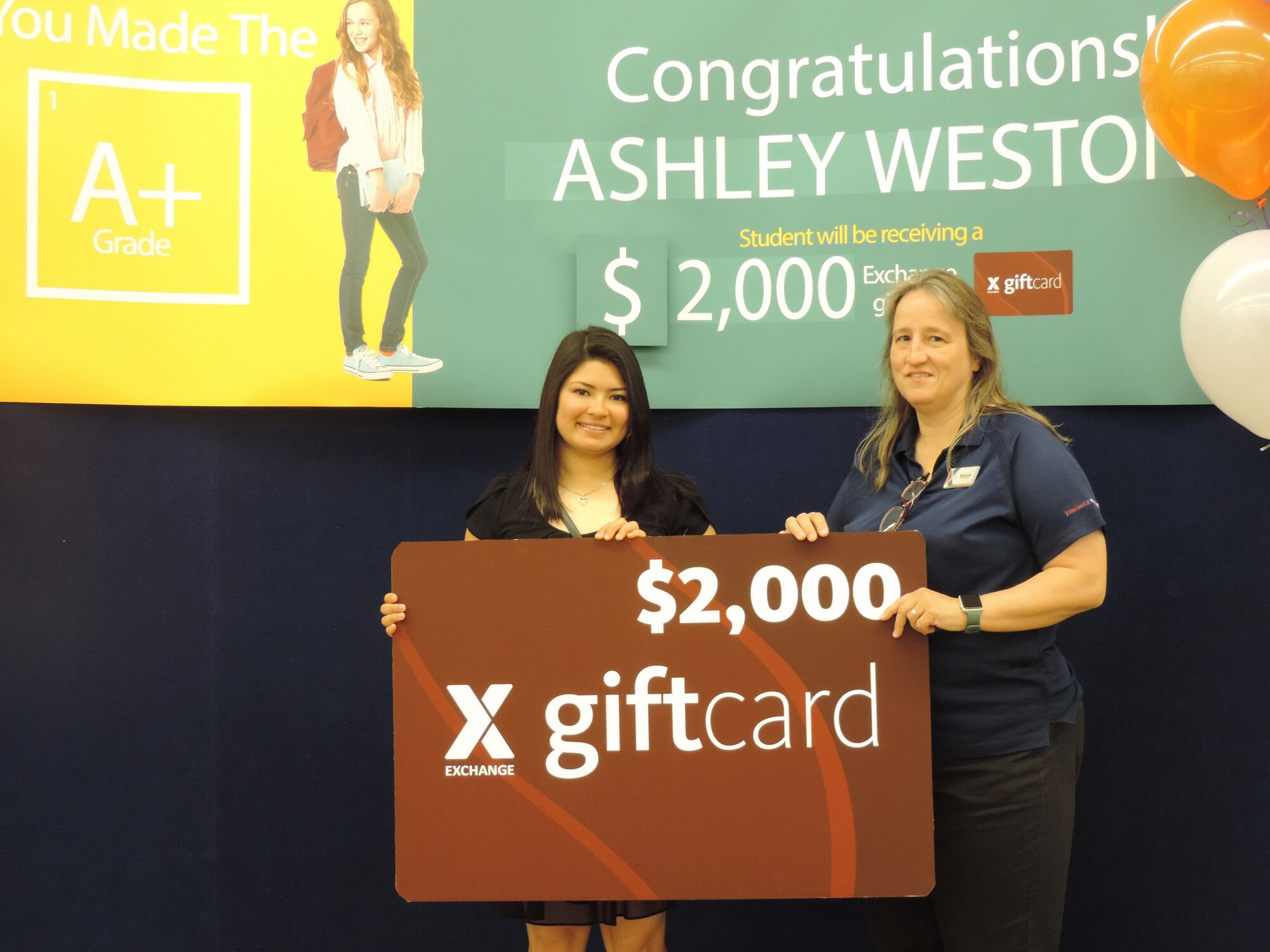 Ashley Weston, a recent high school graduate, took home the grand prize in the Army & Air Force Exchange Service's worldwide You Made the Grade sweepstakes. She was honored at the Joint Base San Antonio-Randolph Exchange by Exchange Operations Manager Brenda Frego on July 25. (Army & Air Force Exchange Service Photo by Roxann Madison)