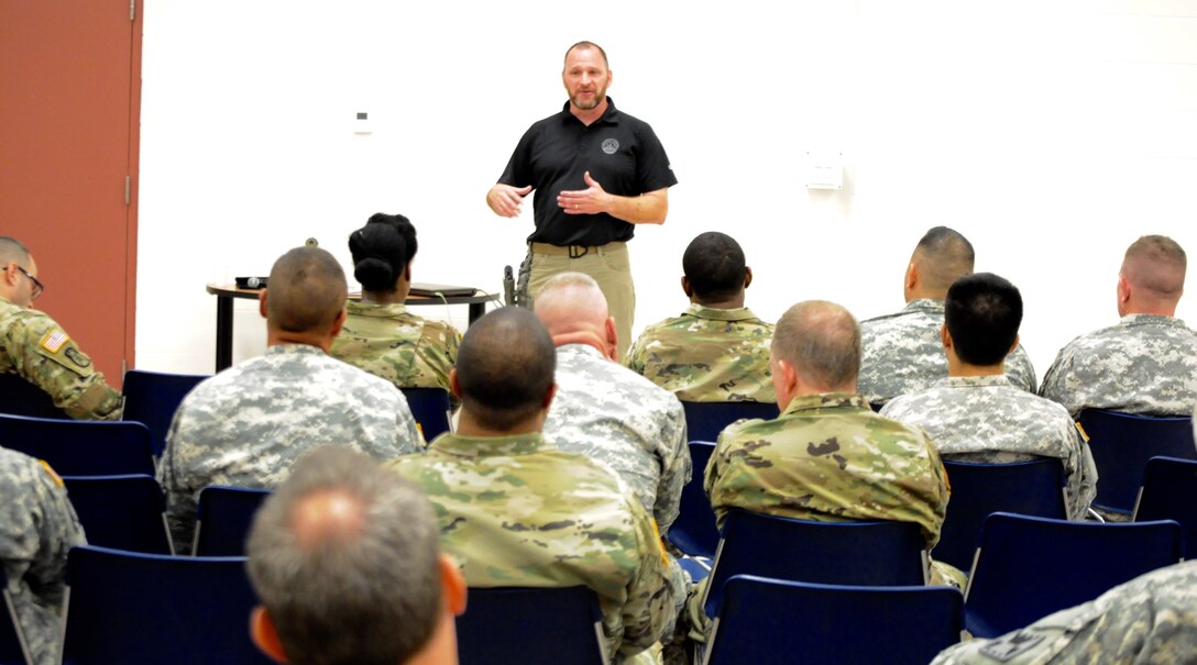 FBI Special Agent Michael Culloton explains the dangers, communalities, law enforcement prevention efforts, and best reactive and proactive responses to an active shooter event, to Soldiers of the 416th Theater Engineer Command, in Darien, Ill. The training provided by Special Agent Culloton gave Soldiers tools to react and protect themselves in an active shooter situation, Aug. 6, 2016. (U.S. Army photo by Spc. Brianna Saville/Released)