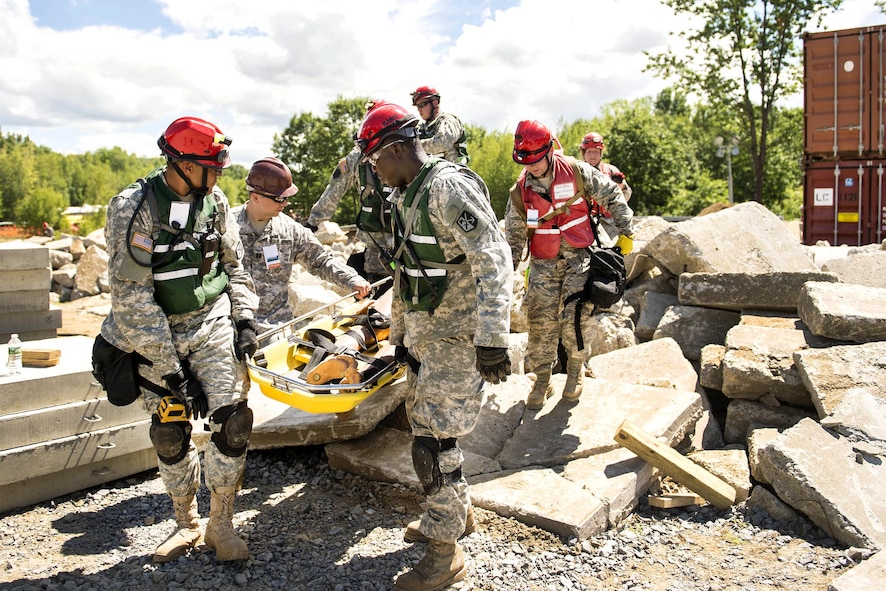 Guardsmen carry a stretcher with a simulated casualty.