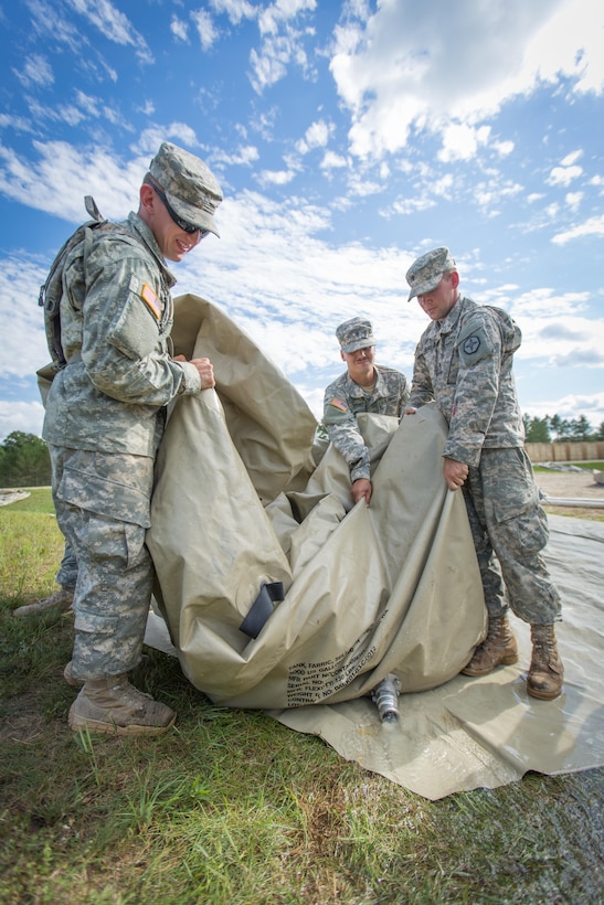 U.S. Army Soldiers of the 651st Quartermaster Company, Casper, Wyo., empty a water storage bladder during Combat Support Training Exercise (CSTX) 86-16-03 at Fort McCoy, Wis., August 7, 2016. The 84th Training Command’s third and final Combat Support Training Exercise of the year hosted by the 86th Training Division at Fort McCoy, Wis. is a multi-component and joint endeavor aligned with other reserve component exercises. (U.S. Army photo by Spc. John Russell/Released)
