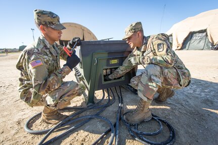 U.S. Army Soldiers Pfc. Francisco Martinez (left) and Pfc. Brendon Amaro, 47th Combat Support Hospital, 62nd Medical Brigade, set up a power distribution box during Combat Support Training Exercise (CSTX) 86-16-03 at Fort McCoy, Wis., August 6, 2016. The 84th Training Command’s third and final Combat Support Training Exercise of the year hosted by the 86th Training Division at Fort McCoy, Wis. is a multi-component and joint endeavor aligned with other reserve component exercises. (U.S. Army photo by Spc. John Russell/Released)