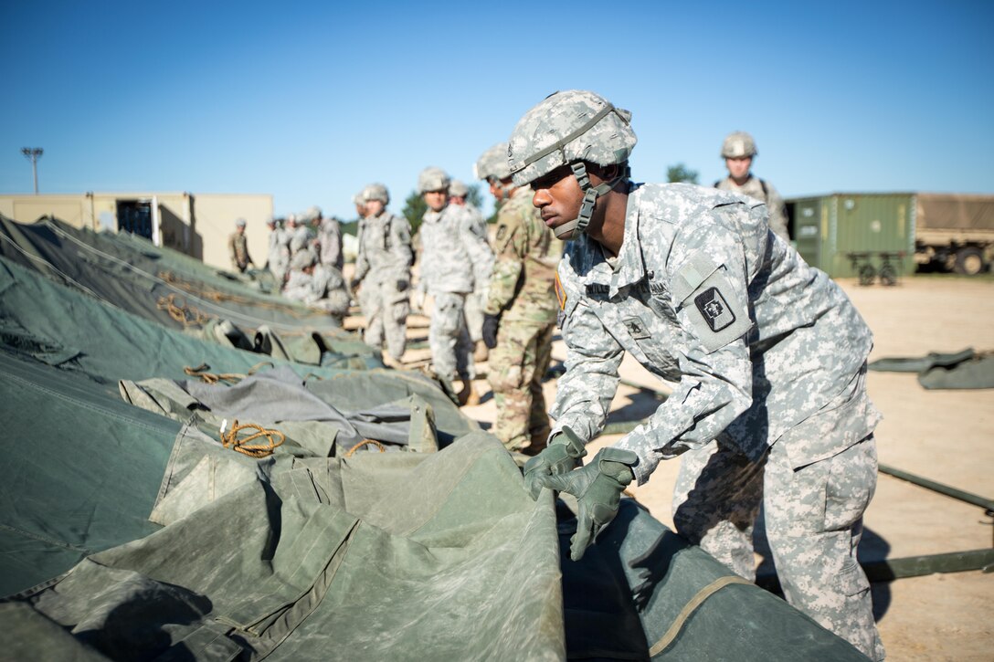 U.S. Army Soldiers from the 47th Combat Support Hospital, 62nd Medical Brigade, set up a tent  during Combat Support Training Exercise (CSTX) 86-16-03 at Fort McCoy, Wis., August 6, 2016. The 84th Training Command’s third and final Combat Support Training Exercise of the year hosted by the 86th Training Division at Fort McCoy, Wis. is a multi-component and joint endeavor aligned with other reserve component exercises. (U.S. Army photo by Spc. John Russell/Released)