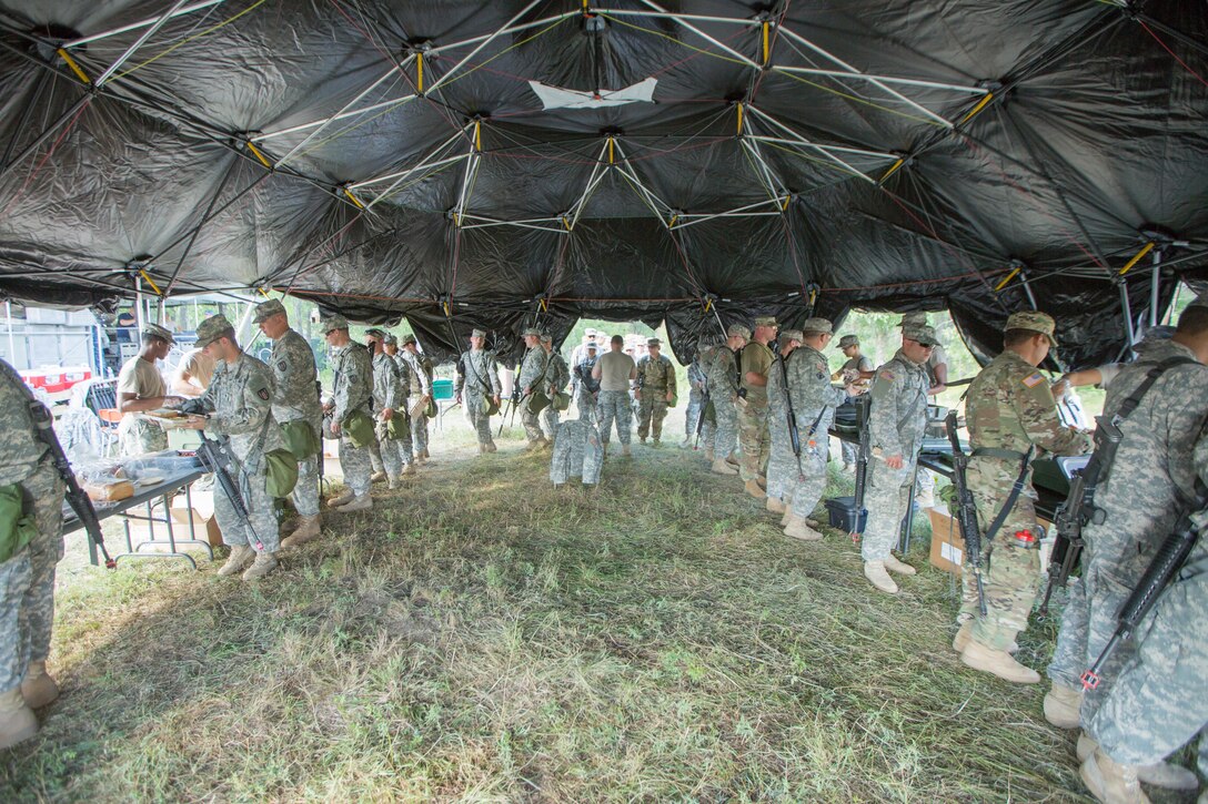 U.S. Army Reserve Soldiers of the 644th Regional Support Group attend the first hot meal at Tactical Assembly Area Liberty during Combat Support Training Exercise (CSTX) 86-16-03 at Fort McCoy, Wis., August 8, 2016. The 84th Training Command’s third and final Combat Support Training Exercise of the year hosted by the 86th Training Division at Fort McCoy, Wis. is a multi-component and joint endeavor aligned with other reserve component exercises. (U.S. Army photo by Spc. John Russell/Released)