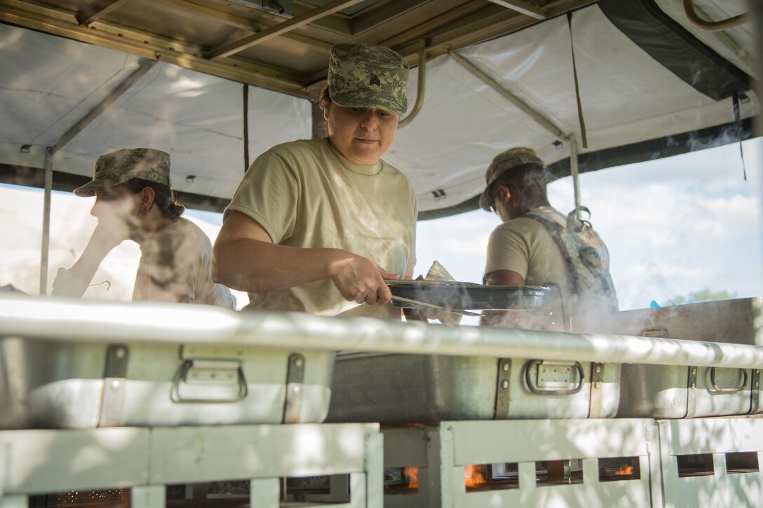 U.S. Army Sgt. Marisela Delehanty, 459th Transportation Company, Elwood, Ill., prepares food inside a Mobile Kitchen Trailer during Combat Support Training Exercise (CSTX) 86-16-03 at Fort McCoy, Wis., August 8, 2016. The 84th Training Command’s third and final Combat Support Training Exercise of the year hosted by the 86th Training Division at Fort McCoy, Wis. is a multi-component and joint endeavor aligned with other reserve component exercises. (U.S. Army photo by Spc. John Russell/Released)