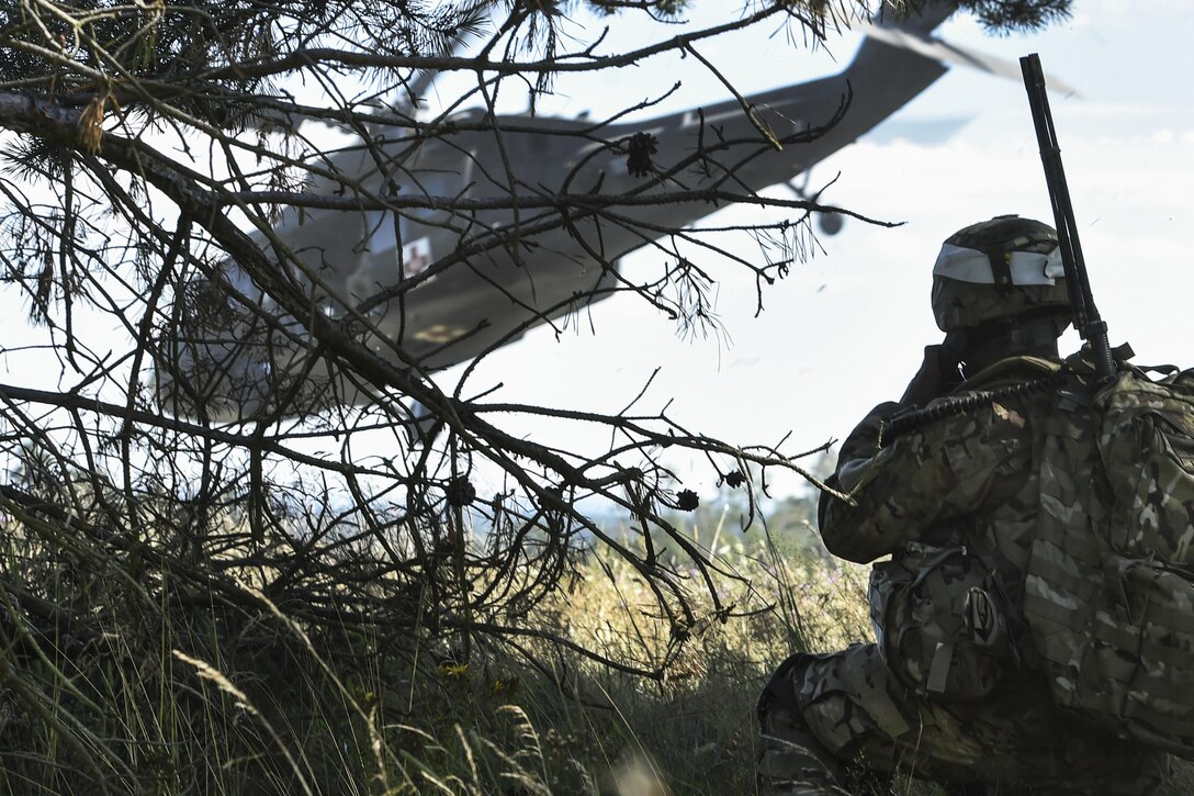 Army Sgt. 1st Class Dominador Rubang calls for medical support during the 2016 European Best Warrior Competition at the 7th Army Training Command's Grafenwoehr Training Area, Germany, Aug. 8, 2016. The event determines the year's top junior officer, noncommissioned officer and soldier. Rubang is assigned to the U.S. Army NATO Brigade. Army photo by Gertrud Zach