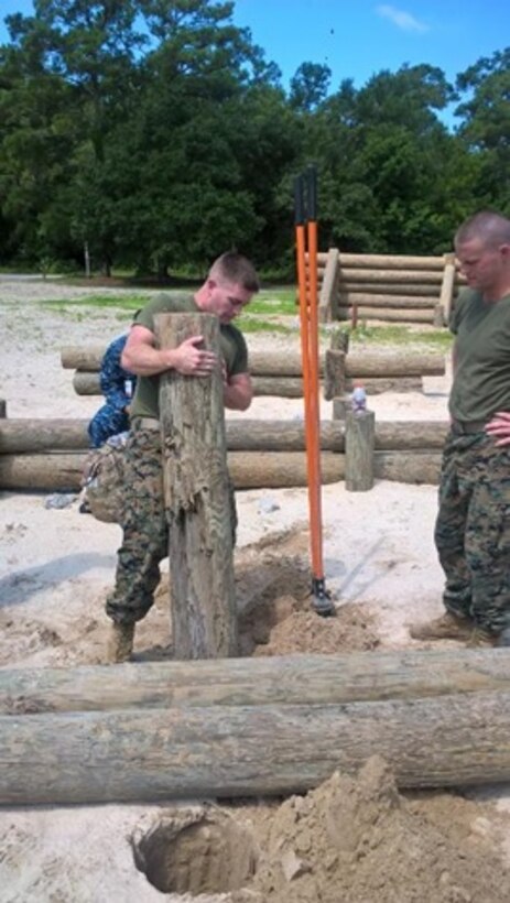 On July 20, 2016 Second Lieutenant Timothy Duggins, a Marine attached to Combat Engineer Officer course 6-16 (CEO 6-16); uses a log as a post and reinforces it with wire to construct a log hurdle obstacle. Log hurdle obstacles are used to slow down vehicle mobility. 

