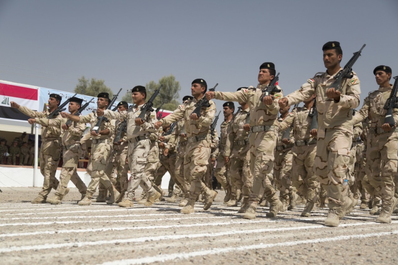 Iraqi soldiers assigned to the Iraqi army’s 76th Brigade, 16th Division, march past the reviewing stand during the brigade’s graduation at Camp Taji, Iraq, June 28, 2015. Through advise, assist and build partner-capacity missions, the Combined Joint Task Force – Operation Inherent Resolve’s multinational coalition has trained more than 10,000 Iraqi security force personnel to defeat the Islamic State of Iraq and the Levant. Army photo by Sgt. Charles M. Bailey