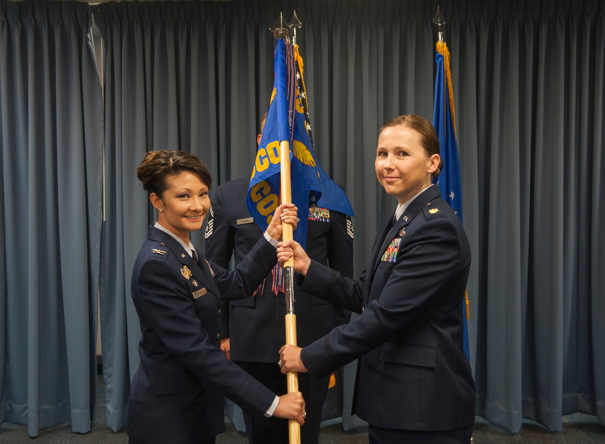 Col. Patricia Csank, 635th Supply Chain Operations Squadron commander, passes the guidon to Maj. Nena Myers, 435th Supply Chain Operations Group commander, Aug. 2 at Scott Air Force Base.The 435th SCOS is resposible for Department of Defense-wide global supply chain management support to over 300 strategic airlift aircraft, off-station support to over 1,500 mobility air forces and special operations aircraft providing global reach support to the warfighter. (U.S.Air Force Photo by Airman Daniel Garcia)