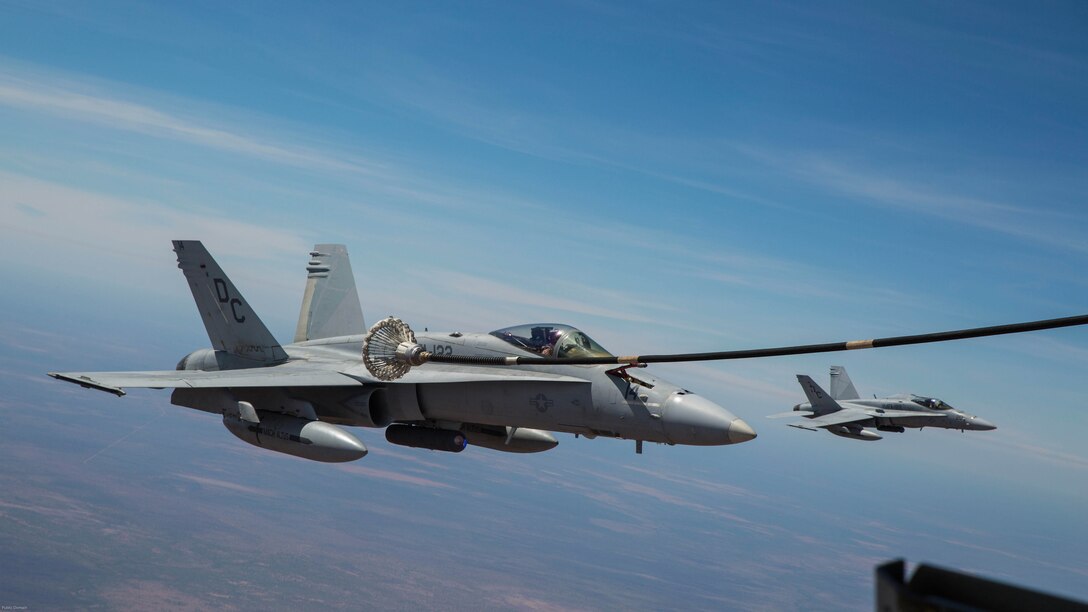An F/A-18C Hornet with Marine Fighter Attack Squadron 122 moves in to catch the basket during an aerial refueling mission with Marine Aerial Refueler Transport Squadron 152 at Royal Australian Air Force Base Tindal, Australia during Exercise Pitch Black 2016, Aug. 9, 2016. VMGR-152 provides aerial refueling and assault support during expeditionary and joint or combined operations like Pitch Black. This exercise is a biennial, three week, multinational, large-force training exercise hosted by RAAF Tindal. 