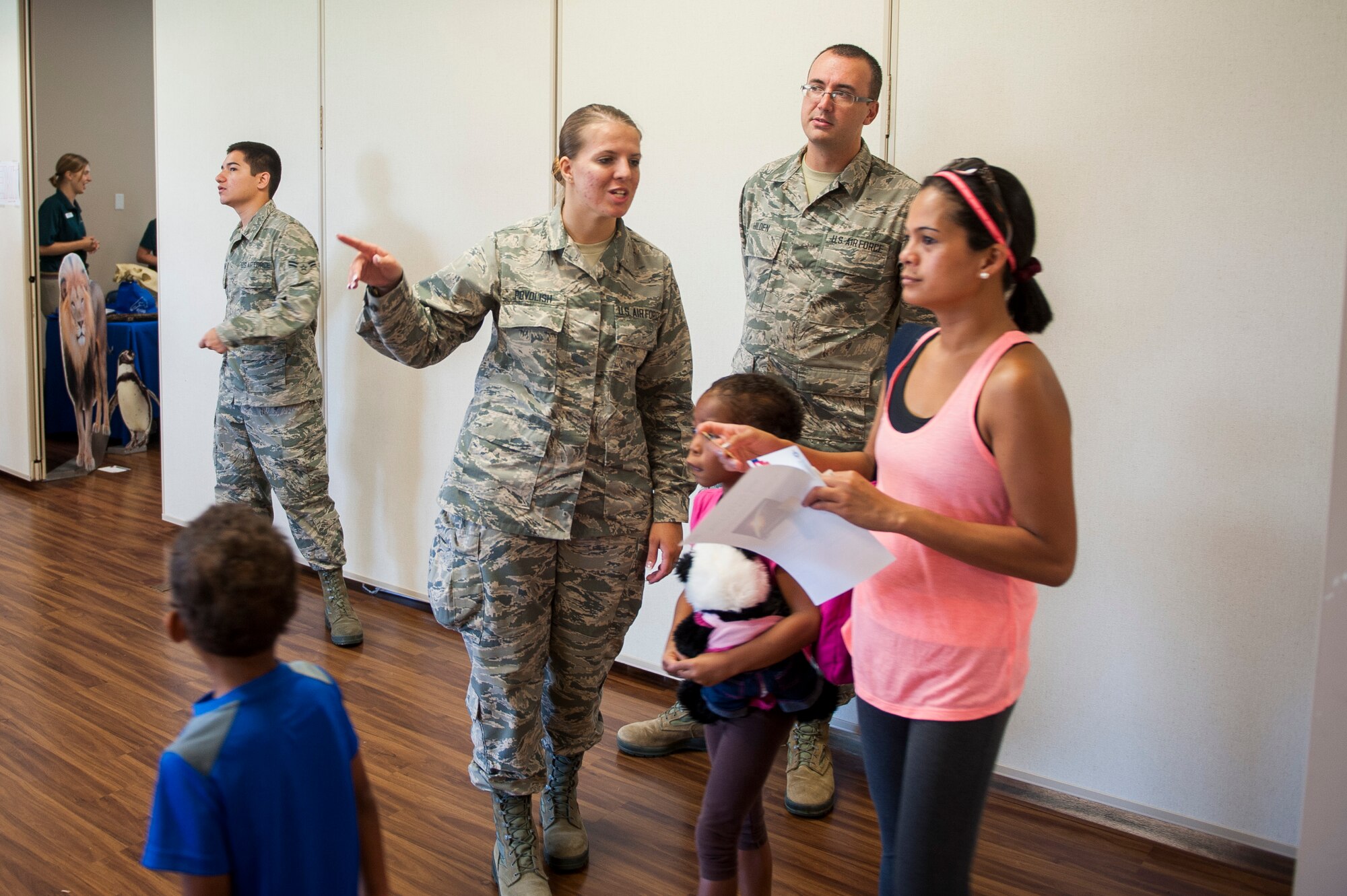 Airman Basic Chelsea Povolish, 126th Air Refueling Wing, helps a family during the Back to School Brigade at Scott Air Force Base, Ill. Aug. 6, 2016. Operation Homefront hosted the event, which supplied backpacks and school supplies to 600 children. (U.S. Air Force photo by Staff Sgt. Clayton Lenhardt/Released)