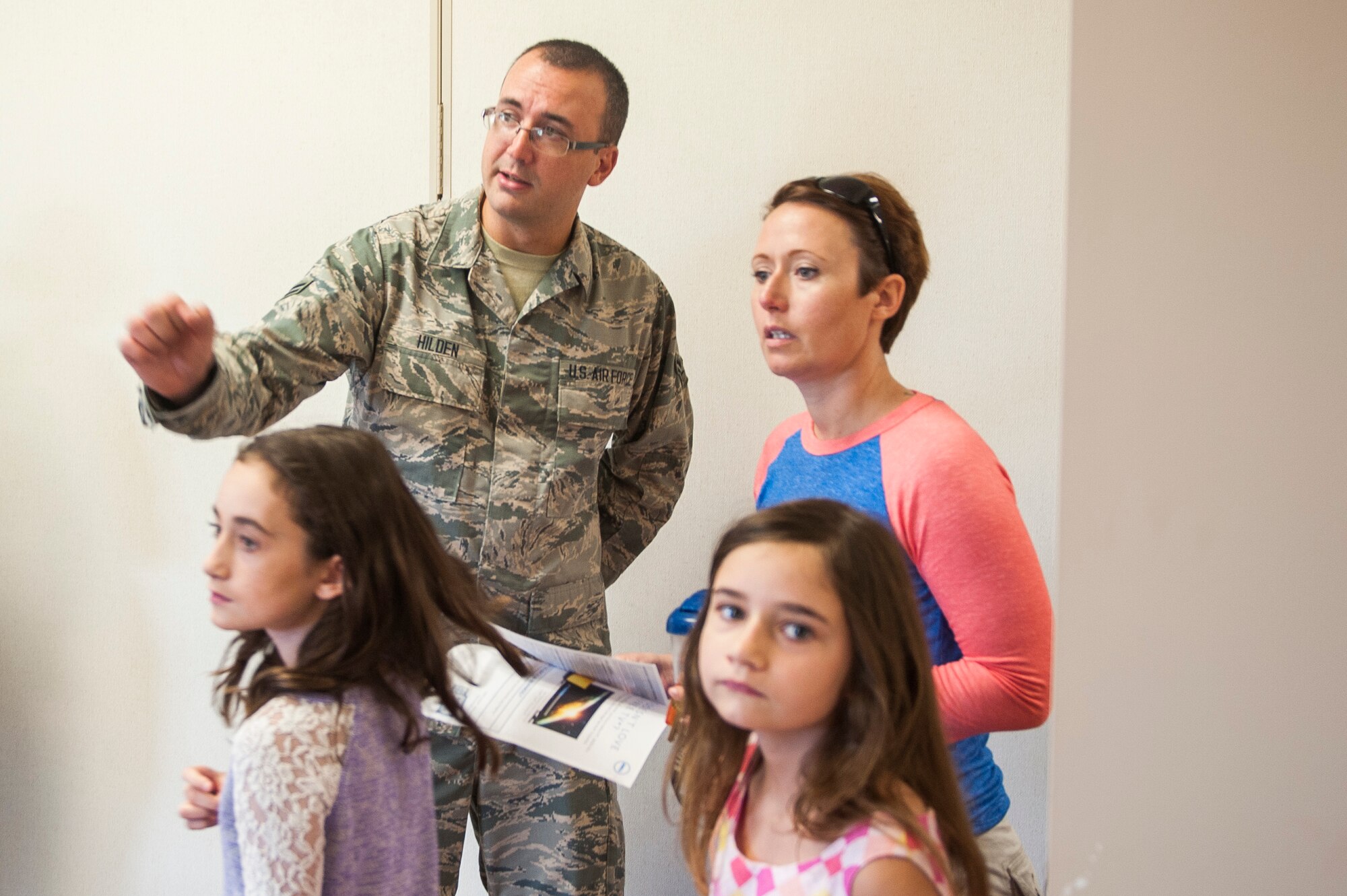Airman 1st Class Mat Hilden, 126th Air Refueling Wing, helps a family during the Back to School Brigade at Scott Air Force Base, Ill. Aug. 6, 2016. Operation Homefront hosted the event, which supplied backpacks and school supplies to 600 children. (U.S. Air Force photo by Staff Sgt. Clayton Lenhardt/Released)