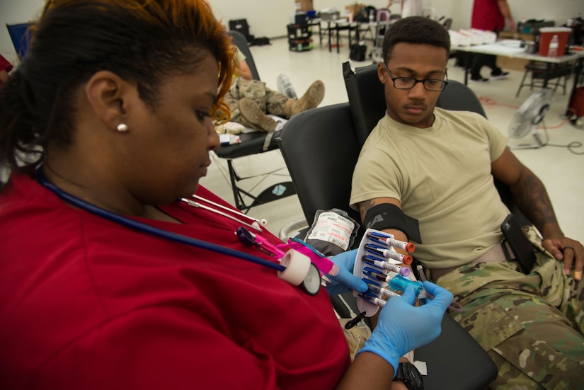 Spc. Curtis Smith, 335th Transportation Detachment watercraft operator, has his blood drawn by Felicia Taylor, American Red Cross phlebotomist collection technician three, during a blood drive at Fort Eustis, Va., August 3, 2016. Smith donates blood every year and began donating blood while attending Deep Creek High School in his hometown of Chesapeake, Va. (U.S. Air Force photo by Staff Sgt. J.D. Strong II)