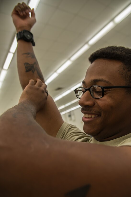 Spc. Curtis Smith, 335th Transportation Detachment watercraft operator, holds gauze over his venipuncture wound after donating blood during a blood drive at Fort Eustis, Va., August 3, 2016. Smith raised his arm above his heart to slow the bleeding from his median cubital vein.(U.S. Air Force photo by Staff Sgt. J.D. Strong II)