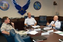 Brig. Gen. John S. Shapland, center, director of Air, Space and Cyberspace Operations for Air Force Materiel Command, listens as Col. Roman L. Hund, right, 66th Air Base Group commander, provides an overview briefing at Hanscom Air Force Base, Mass., Aug. 10, while Col. Dale VanDusen, deputy to the program executive officer for Battle Management, looks on. In addition to Hund's briefing, Shapland also received briefings on Battle Management and Command, Control, Communications, Intelligence and Networks Directorates. (U.S. Air Force photo by Jerry Saslav)