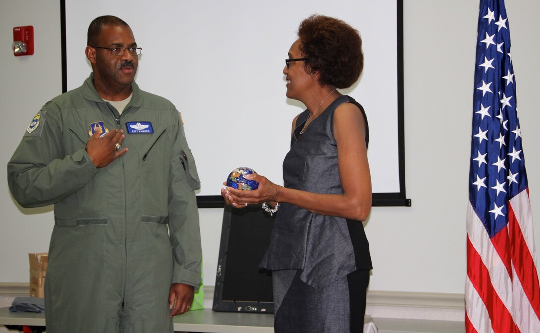 Vice commander of the 932nd Airlift Wing, Col. Esty Ramirez, talked about his first time in Illinois at the unit and the fond memories he had, and he then presented a world globe to retiring Col. Vanessa Mattox, outgoing commander of the 932nd Medical Group.  He noted her outgoing leadership style and she reminded everyone to have fun along the way, and take care of each other while doing the mission.  (U.S. Air Force photo by Maj. Stan Paregien)