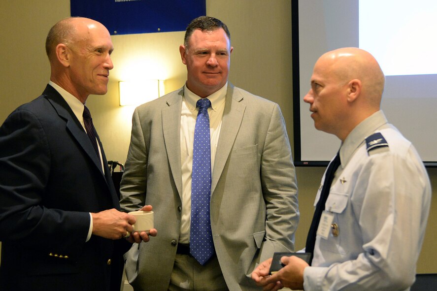 Col. Roman Hund, right, 66th Air Base Group commander, speaks with Bud Vazquez, left, the Military Affairs Council chairman, and John Beatty, the newly appointed Massachusetts Military Task Force executive director, at a MAC networking breakfast at the Crowne Plaza Boston-Woburn Hotel in Woburn, Mass. Aug. 10. Beatty spoke with breakfast attendees about his vision for the Military Task Force, which coordinates among the Commonwealth's six military installations to maximize their efficiency. (U.S. Air Force photo by Linda LaBonte Britt)
