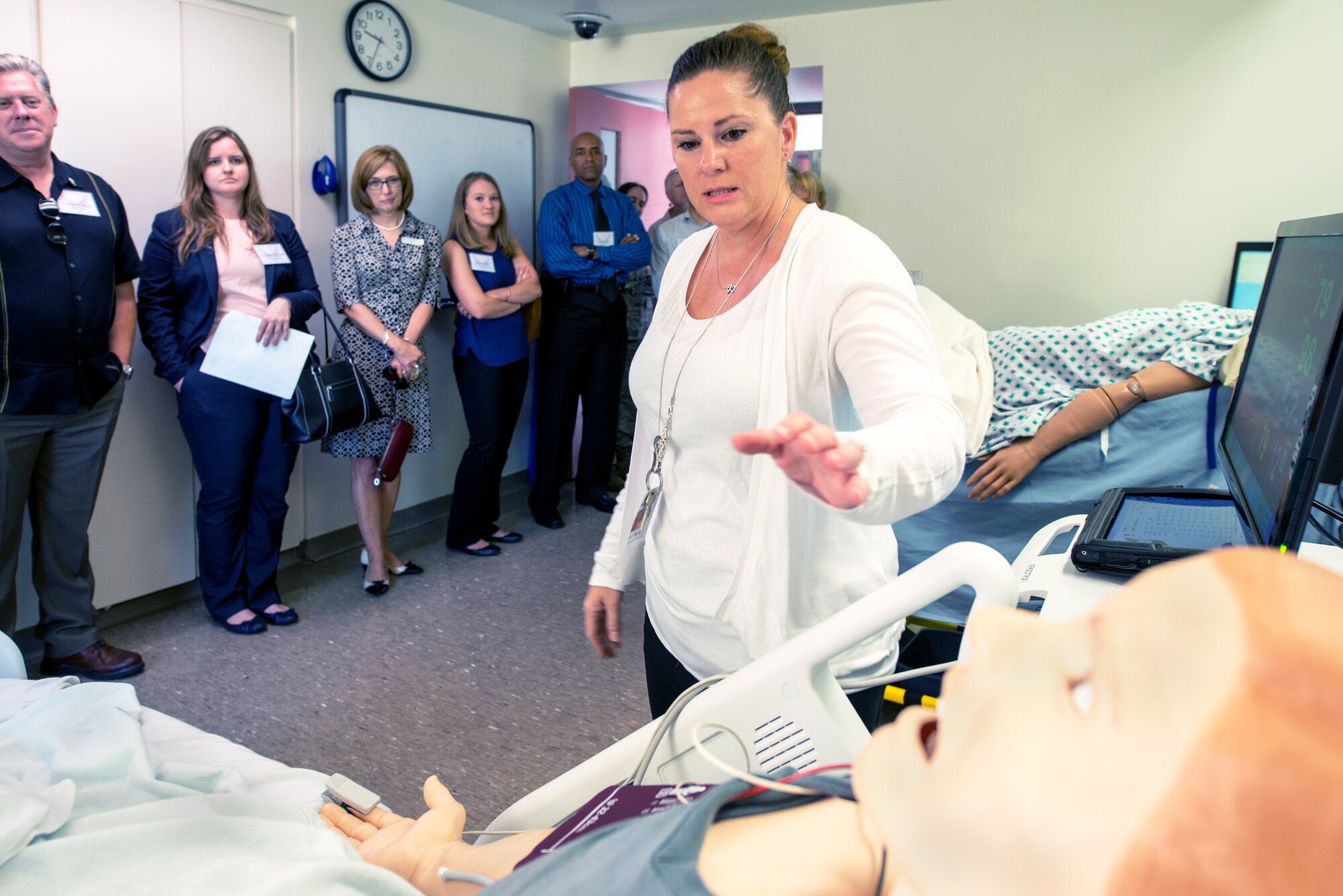 Marilyn Carr, 60th Medical Group, briefs honorary commanders in the virtual ready room on the mannequins during their tour of David Grant USAF Medical Center at Travis Air Force Base, Calif., July 29, 2016. (U.S. Air Force photo by Louis Briscese)
