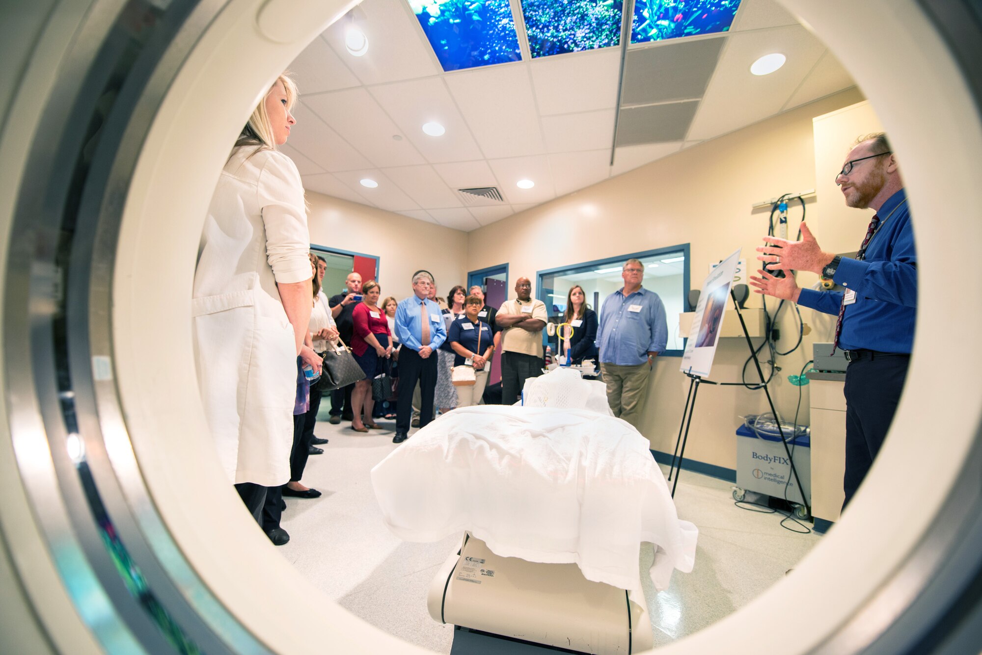 Dr. David Eastman, radiation oncologist, 60th Diagnostics and Therapeutics Squadron, briefs honorary commanders on the computerized tomography (CT) scanner during their tour of David Grant USAF Medical Center at Travis Air Force Base, Calif., July 29, 2016. (U.S. Air Force photo by Louis Briscese)