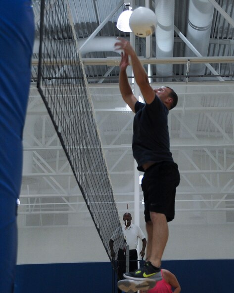 Justin Rushing, 2nd Logistics Readiness Squadron volleyball player, defends the net during the first set of an intramural volleyball game at Barksdale Air Force Base, La., Aug. 8, 2016. In a best of three sets, the 2nd LRS emerged victorious by claiming two and giving up none. (U.S. Air Force photo/Airman 1st Class Stuart Bright)