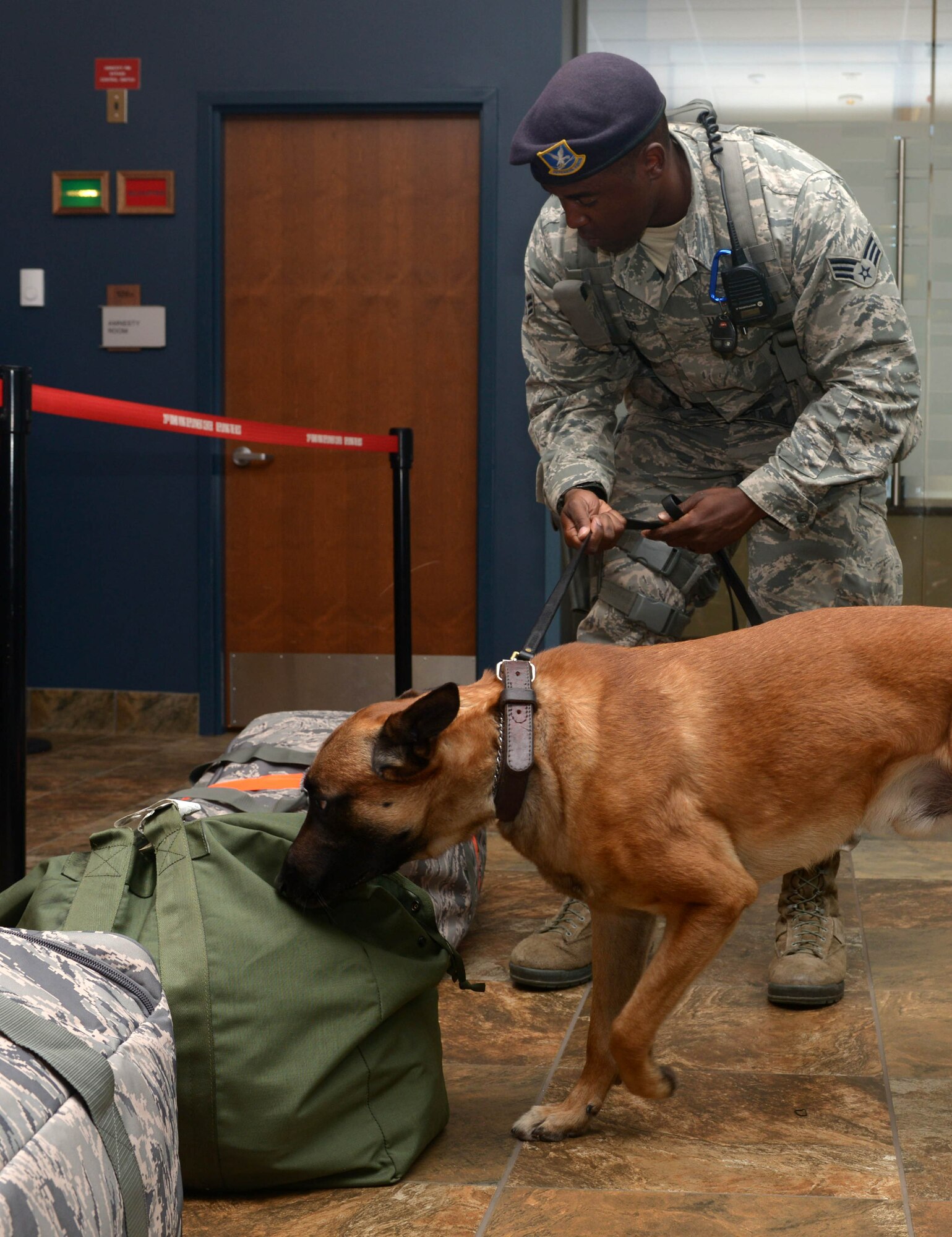 Senior Airman Gabriel Easler, a military working dog handler assigned to the 28th Security Forces Squadron, and his partner, Nnicholas, perform a routine patrol at Ellsworth Air Force Base (AFB), S.D., Aug. 9, 2016. This is the largest deployment Ellsworth AFB has conducted in the past decade, with more than 300 Airmen being deployed to Andersen AFB, Guam. (U.S. Air Force photo by Airman Donald Knechtel) 