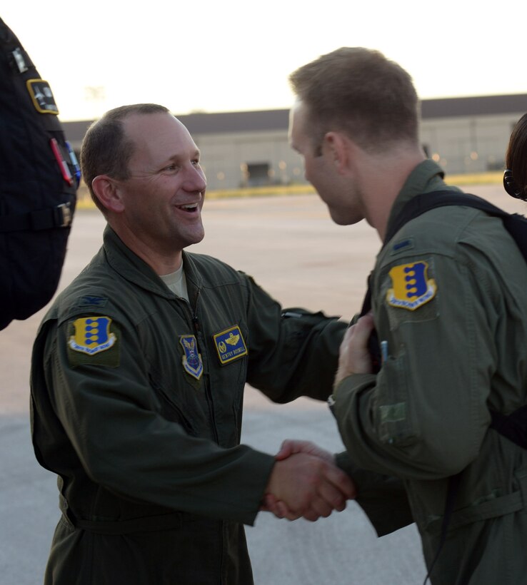 Col. Gentry Boswell, commander of the 28th Bomb Wing, shakes hands with an Airman before they leave for a deployment to Andersen Air Force Base (AFB), Guam, from Ellsworth AFB, S.D., Aug. 9, 2016. Boswell and other base leaders bid Airmen farewell as they boarded a Boeing 767 aircraft. (U.S. Air Force photo by Airman Donald Knechtel) 