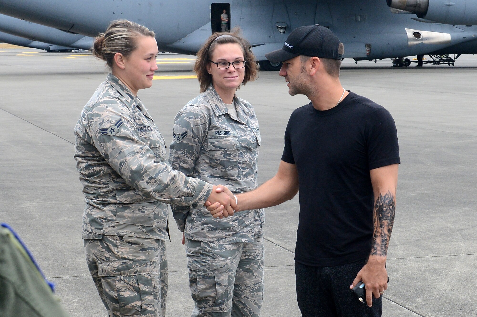 Craig Campbell (right), an American country music singer, visits with Airmen from Team McChord during his United Service Organization tour August 9, 2016 at Joint Base Lewis-McChord, Wash. While visiting McChord Field, Campbell had the opportunity to talk to 62nd Maintenance Group Airmen and loadmasters while touring a McChord C-17 Globemaster III. Later that day, as part of his tour, Campbell performed at Memorial Stadium on JBLM and thanked the men and women of JBLM for their service. (U.S. Air Force photo/Senior Airman Divine Cox)