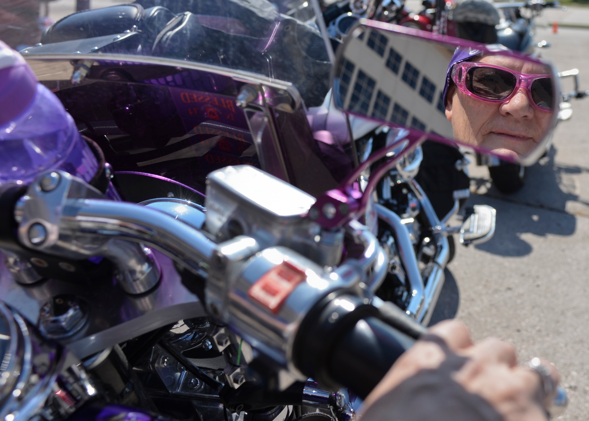 Pam Gunderson, motorcycle enthusiast from Rapid City, S.D., prepares her motorcycle prior to the start of the 16th Annual Dakota Thunder Run on the flight line at Ellsworth Air Force Base, S.D., Aug. 9, 2016. Gunderson, along with her two sisters, has participated in the ride for six consecutive years and enjoys that the military can be appreciated in such a fun way. (U.S. Air Force photo by Senior Airman Anania Tekurio/Released)