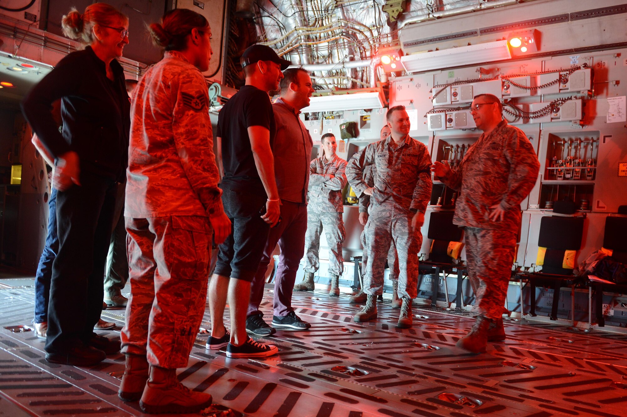 Craig Campbell (left center), an American country music singer, visits with Airmen from Team McChord during his United Service Organization tour August 9, 2016 at Joint Base Lewis-McChord, Wash. While visiting McChord Field, Campbell had the opportunity to talk to 62nd Maintenance Group Airmen and loadmasters while touring a McChord C-17 Globemaster III. Later that day, as part of his tour, Campbell performed at Memorial Stadium on JBLM and thanked the men and women of JBLM for their service. (U.S. Air Force photo/Senior Airman Divine Cox)