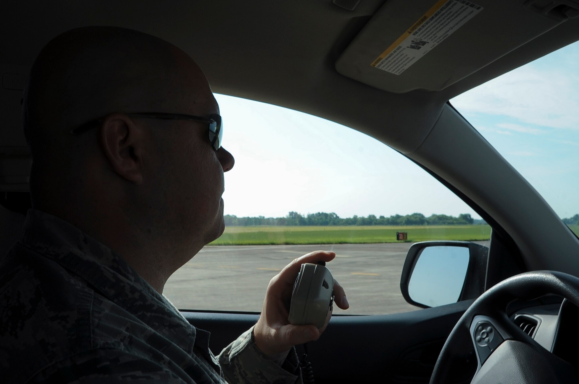 Tech Sgt. Nathan Strickland, 2nd Operations Support Squadron NCO in charge airfield management operations, makes contact with the control tower as he drives on the runway at Barksdale Air Force Base, La., August 9, 2016. Strickland inspected the runway for potential hazards. (U.S. Air Force Photo/Airman 1st Class Stuart Bright)