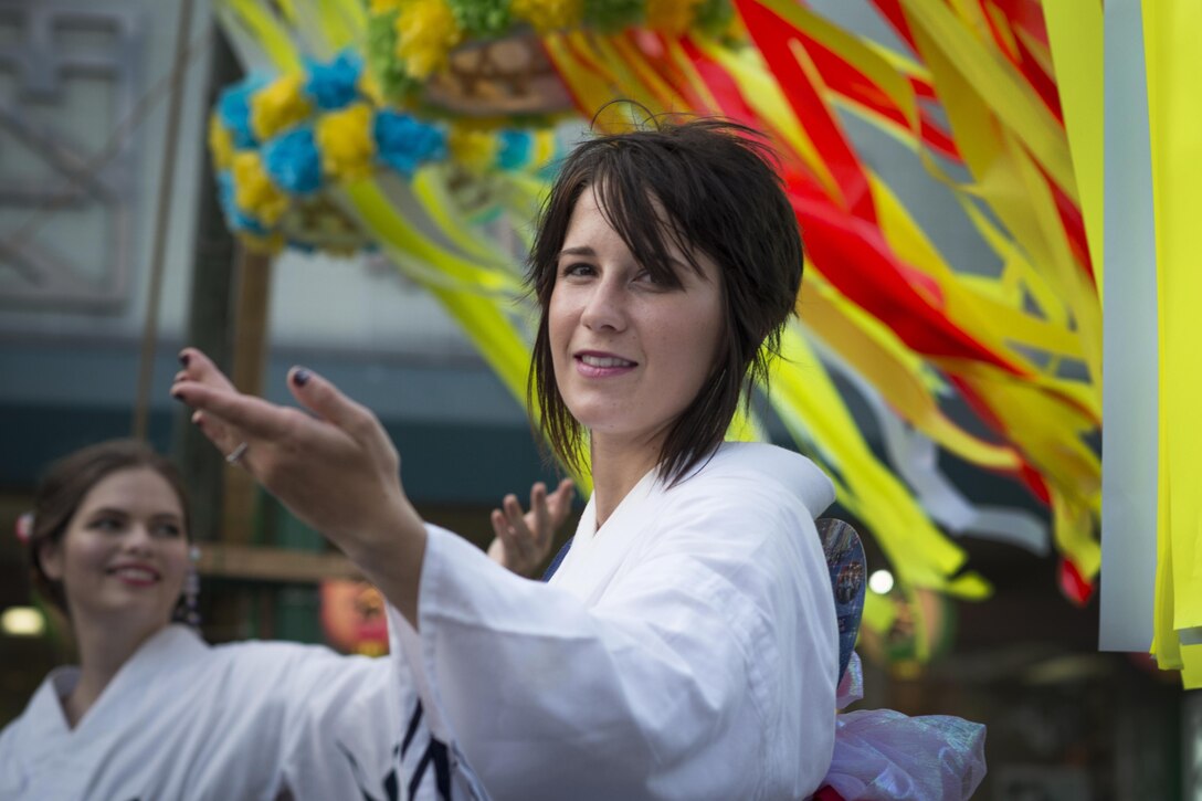A Tanabata Dancer participates in a parade during the 66th Annual Fussa Tanabata Festival at Fussa City, Japan, Aug. 5, 2016. The Tanabata Dancers, from Yokota Air Base, perform at local festivals in order to promote goodwill and cultural exchange between the U.S. and Japan. (U.S. Air Force photo by Staff Sgt. Cody H. Ramirez/Released)