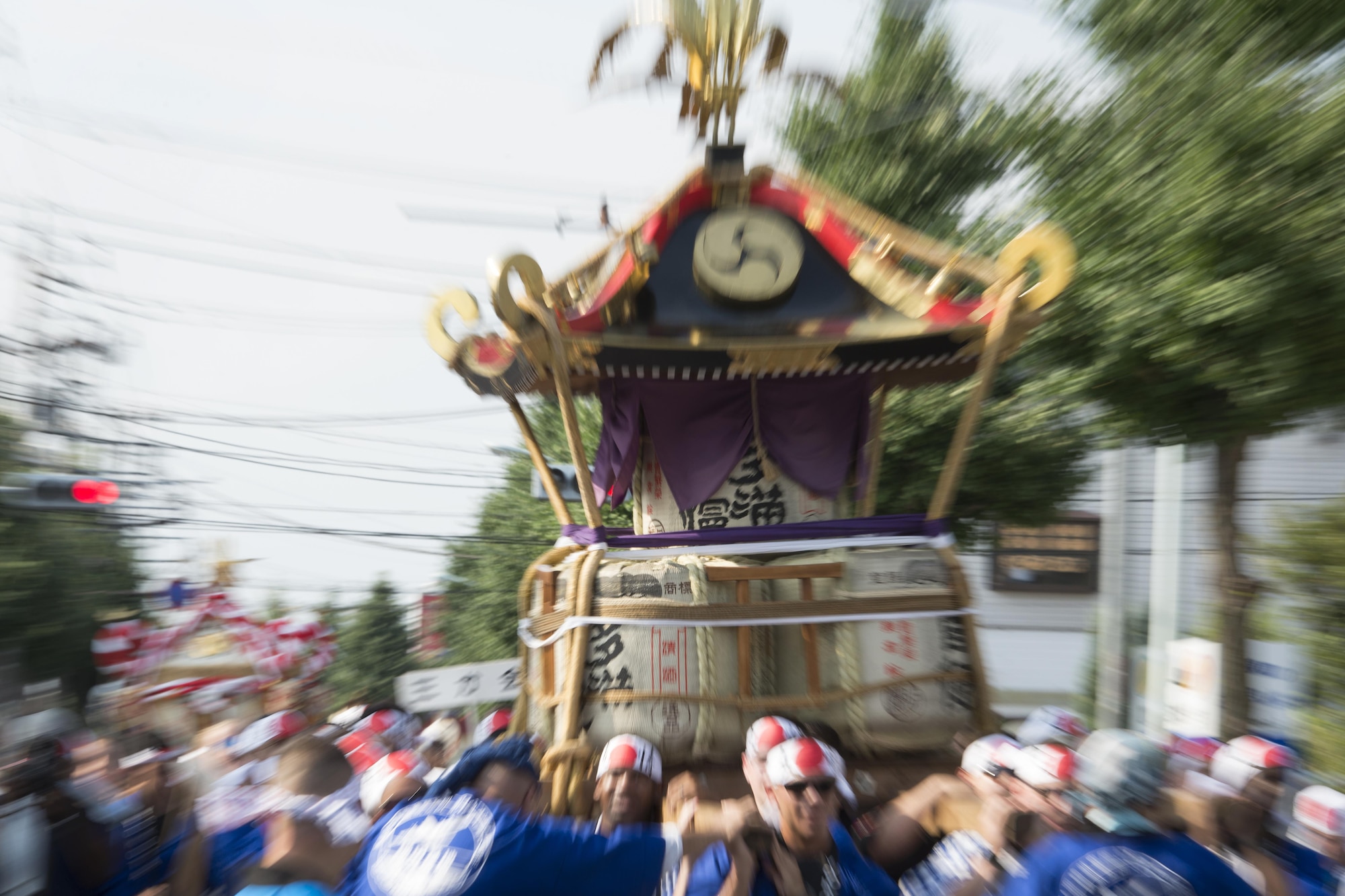 Members of Yokota Air Base carry a mikoshi, or portable shrine, down a road in Fussa City, Japan, Aug. 5, 2016, during the 66th Annual Tanabata Festival. Every year, members of Yokota Air Base participate in the festival by carrying a mikoshi, or portable shrine, dancing in a parade and eating local foods and drinks. (U.S. Air Force photo by Staff Sgt. Cody H. Ramirez/Released)