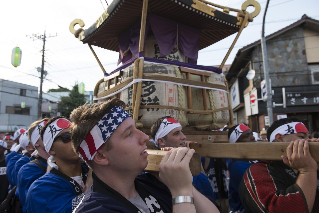 Members of Yokota Air Base carry a mikoshi, or portable shrine, during the 66th Annual Tanabata Festival at Fussa City, Japan, Aug. 5, 2016. Yokota Airmen have attended the festival since 1958 and have actively participated in carrying the mikoshi since 1975. (U.S. Air Force photo by Staff Sgt. Cody H. Ramirez/Released)