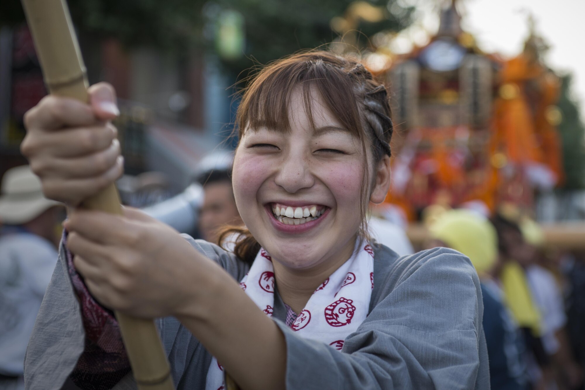 A young woman carries a lantern in front of a mikoshi, or portable shrine, during the 66th Annual Fussa Tanabata Festival at Fussa City, Japan, Aug. 5, 2016. Community members participate in many events during the festival, including carrying mikoshi, dancing, and running food and drink booths. (U.S. Air Force photo by Staff Sgt. Cody H. Ramirez/Released)