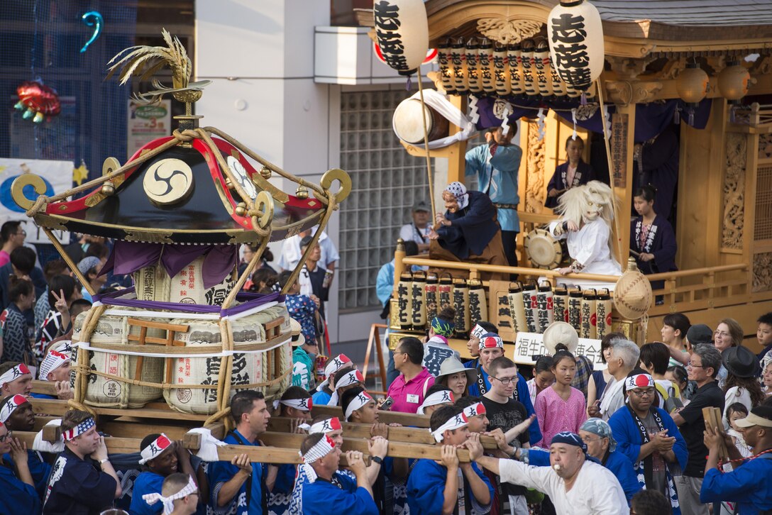 Members from Yokota Air Base carry a mikoshi, or portable shrine, during the 66th Annual Tanabata Festival at Fussa City, Japan, Aug. 5, 2016. Nearly 100 volunteers from Yokota carried the shrine during this year's festival; Yokota Airmen have attended the festival since 1958 and have actively participated in carrying a mikoshi since 1975.
(U.S. Air Force photo by Staff Sgt. Cody H. Ramirez/Released)
